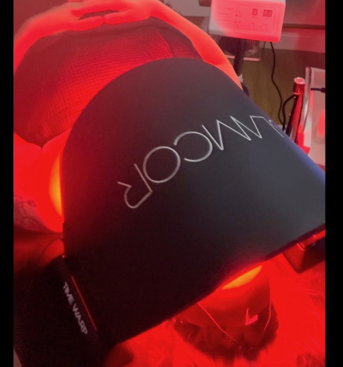 Client relaxing under LED light therapy